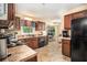 Traditional kitchen featuring brown cabinetry, laminate countertops, and black appliances at 258 Cristy Dr, Dallas, GA 30157