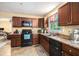Well-equipped kitchen with dark wood cabinetry, modern appliances, and ample counter space at 258 Cristy Dr, Dallas, GA 30157