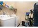 Laundry room featuring a washer, dryer, storage shelving, and neutral walls at 258 Cristy Dr, Dallas, GA 30157