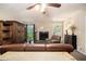 Cozy living room featuring a fireplace, leather furniture, and a ceiling fan at 258 Cristy Dr, Dallas, GA 30157