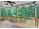 Relaxing covered back porch with natural wood and a scenic wooded view at 3570 Bulloch Lake Rd, Loganville, GA 30052