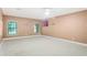 Tan painted bedroom with natural light and neutral carpeting at 3570 Bulloch Lake Rd, Loganville, GA 30052