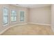 Bright bedroom with three windows and neutral carpeting throughout at 3570 Bulloch Lake Rd, Loganville, GA 30052