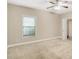 Bedroom features neutral carpet and paint, large window and ceiling fan at 3570 Bulloch Lake Rd, Loganville, GA 30052