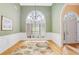 Elegant dining room with hardwood floors, chandelier, and large window at 3570 Bulloch Lake Rd, Loganville, GA 30052