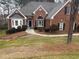 Charming brick home featuring a well-manicured lawn, arched windows, and a welcoming front entrance at 3570 Bulloch Lake Rd, Loganville, GA 30052