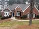 Charming brick home featuring a well-manicured lawn, arched windows, and a welcoming front entrance at 3570 Bulloch Lake Rd, Loganville, GA 30052
