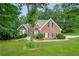 Charming brick home with well-manicured lawn and mature trees, showcasing curb appeal at 3570 Bulloch Lake Rd, Loganville, GA 30052