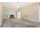 Large living room with fireplace, plush carpet, and ample natural light at 3570 Bulloch Lake Rd, Loganville, GA 30052