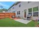 Cozy backyard features a wood deck, patio, grill, and privacy fence at 4974 Whiteoak Walk Se # 21, Smyrna, GA 30080