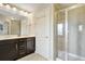Bathroom featuring a glass enclosed shower, dual sink vanity, and modern lighting fixtures at 4974 Whiteoak Walk Se # 21, Smyrna, GA 30080