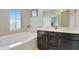 Bright bathroom featuring a soaking tub, dual sink vanity, and ample counter space at 4974 Whiteoak Walk Se # 21, Smyrna, GA 30080