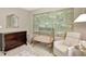 Well appointed Bedroom with a crib, a dresser, a glider and decorative wall art at 4974 Whiteoak Walk Se # 21, Smyrna, GA 30080