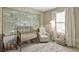 Bright Bedroom with a decorative mural, a crib, a glider and a plush rug at 4974 Whiteoak Walk Se # 21, Smyrna, GA 30080