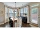 Bright dining area featuring wood floors, a modern chandelier, and a door to the outside at 4974 Whiteoak Walk Se # 21, Smyrna, GA 30080