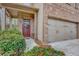 Close up of home exterior with a two-car garage and inviting brick porch at 4974 Whiteoak Walk Se # 21, Smyrna, GA 30080