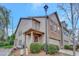 Inviting two-story home with a brick facade, covered porch, and manicured landscaping at 4974 Whiteoak Walk Se # 21, Smyrna, GA 30080