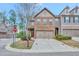 Charming brick two-story townhome with a two-car garage, landscaping, and inviting front porch at 4974 Whiteoak Walk Se # 21, Smyrna, GA 30080