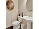 Cozy powder room with pedestal sink, mirror, and toilet at 4974 Whiteoak Walk Se # 21, Smyrna, GA 30080
