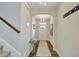 Inviting hallway with hardwood floors, neutral paint, elegant light fixture, and coat rack at 4974 Whiteoak Walk Se # 21, Smyrna, GA 30080