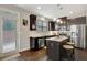 Kitchen features stainless steel appliances, dark cabinets, and an eat-in kitchen island at 4974 Whiteoak Walk Se # 21, Smyrna, GA 30080