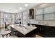 Open kitchen featuring an island with countertop seating, dark cabinets, and stainless steel appliances at 4974 Whiteoak Walk Se # 21, Smyrna, GA 30080