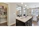 View of kitchen island, pantry and dining room with modern light fixture at 4974 Whiteoak Walk Se # 21, Smyrna, GA 30080