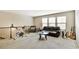 Open loft area featuring plush carpeting, a leather sofa, workout bike and multiple guitars at 4974 Whiteoak Walk Se # 21, Smyrna, GA 30080