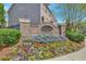 Welcoming entrance sign to the White Oak community with vibrant flowers at 4974 Whiteoak Walk Se # 21, Smyrna, GA 30080