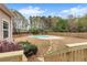 Inviting backyard features an in-ground pool and a stepping stone path, perfect for outdoor relaxation and enjoyment at 52 Weatherstone Way, Dallas, GA 30157