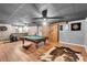 Basement area boasts a pool table and stylish design, creating an inviting space for recreation and relaxation at 52 Weatherstone Way, Dallas, GA 30157
