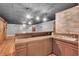 Basement bar features a sink and wooden accents, creating a stylish space for entertaining guests at 52 Weatherstone Way, Dallas, GA 30157