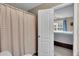 Bathroom featuring a shower with a striped curtain, leading to a bedroom at 52 Weatherstone Way, Dallas, GA 30157