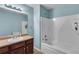 Clean bathroom featuring a vanity, bathtub and shower combination with modern lighting at 52 Weatherstone Way, Dallas, GA 30157
