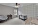 Well-lit room with a crib, modern wallpaper, and ceiling fan at 52 Weatherstone Way, Dallas, GA 30157