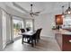 Dining area with three large windows, table set for four, and easy access to outdoor deck at 52 Weatherstone Way, Dallas, GA 30157