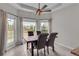 Dining area with a three-window bay, a modern table and chairs, and tiled floors at 52 Weatherstone Way, Dallas, GA 30157