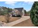 Exterior of home with stone accents, a covered front porch, and a long driveway at 52 Weatherstone Way, Dallas, GA 30157