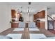 Open kitchen area with tile floors, granite countertops, and access to kitchen and staircase at 52 Weatherstone Way, Dallas, GA 30157