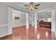 Spacious living room featuring hardwood floors, decorative columns, and open access to another area at 52 Weatherstone Way, Dallas, GA 30157