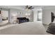 Spacious living room with a ceiling fan, comfortable sofa, and ample natural light at 52 Weatherstone Way, Dallas, GA 30157