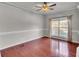Bright living room with hardwood floors, crown molding, and natural light from a large window at 52 Weatherstone Way, Dallas, GA 30157