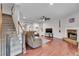 Bright living room with hardwood floors, a stone fireplace, and an open layout to the rest of the house at 52 Weatherstone Way, Dallas, GA 30157