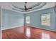 Main bedroom boasting a tray ceiling, hardwood floors and natural lighting at 52 Weatherstone Way, Dallas, GA 30157