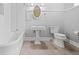 Clean bathroom with classic white tile, pedestal sink, and a tub with shower at 285 Kennesaw Nw Ave, Marietta, GA 30060