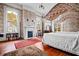Bedroom with floral wallpaper, fireplace, twin canopy beds, and hardwood floors at 285 Kennesaw Nw Ave, Marietta, GA 30060