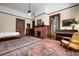 Spacious bedroom featuring a bed, fireplace, piano, hardwood floors and natural light from the large windows at 285 Kennesaw Nw Ave, Marietta, GA 30060