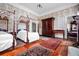 Bedroom featuring twin canopy beds, decorative rugs on hardwood floors, and floral wallpaper at 285 Kennesaw Nw Ave, Marietta, GA 30060