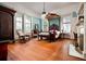 Spacious bedroom with a canopy bed, rocking chair, fireplace, hardwood floors, and large windows at 285 Kennesaw Nw Ave, Marietta, GA 30060