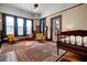Bedroom featuring a bed, fireplace, multiple chairs, hardwood floors, and natural light from the large windows at 285 Kennesaw Nw Ave, Marietta, GA 30060